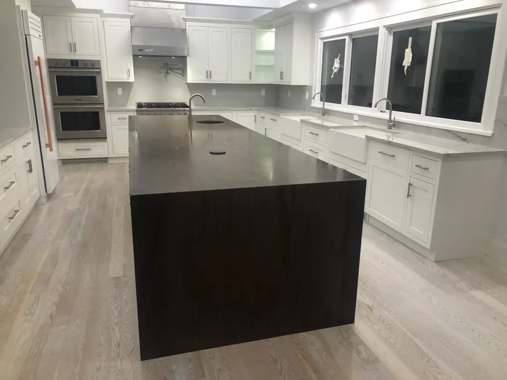 Kitchen with a dark stone waterfall island