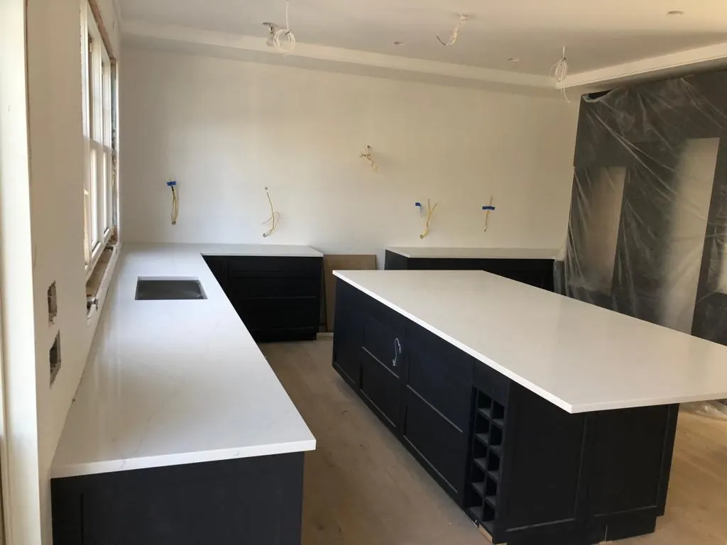 Kitchen with white countertops and a dark island