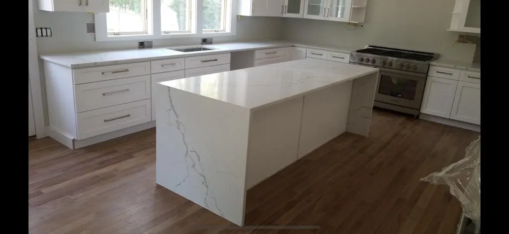 White waterfall island in a new kitchen