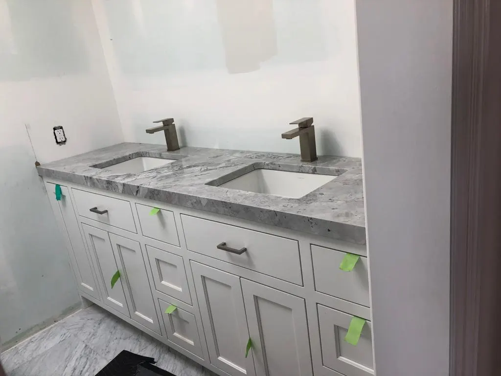 Double vanity with a veined stone top